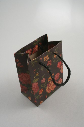 Black Floral Printed Kraft Paper Gift Bag with Black Corded Handles. Size Approx 11cm x 8cm x 5cm.