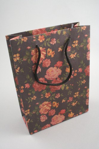 Black Floral Printed Kraft Paper Gift Bag with Black Corded Handles. Size Approx 20cm x 15cm x 6cm.