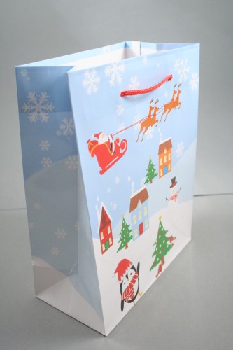 Christmas Scene Glossy Gift Bag with Blue Background and Red Cord Handles. Approx Size 23cm x 18cm x 9cm