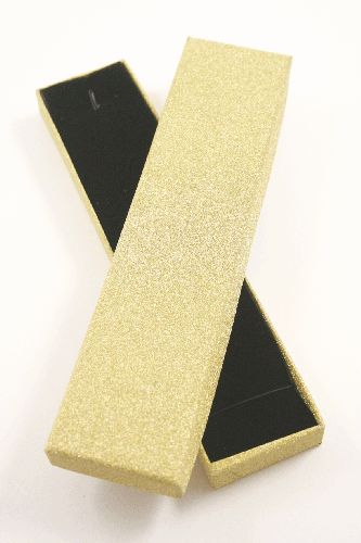 Gold Glitter Gift Box. Size Approx 21cm x 4.5cm x 1.8cm. This box has a black flocked foam pad insert with a small wire hook at one end and an elasticated fitting at the other suitable for bracelets