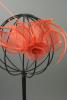 Coral Looped Fabric Flower and Feather Fascinator on a Ribbon Wrapped Aliceband.  - view 1